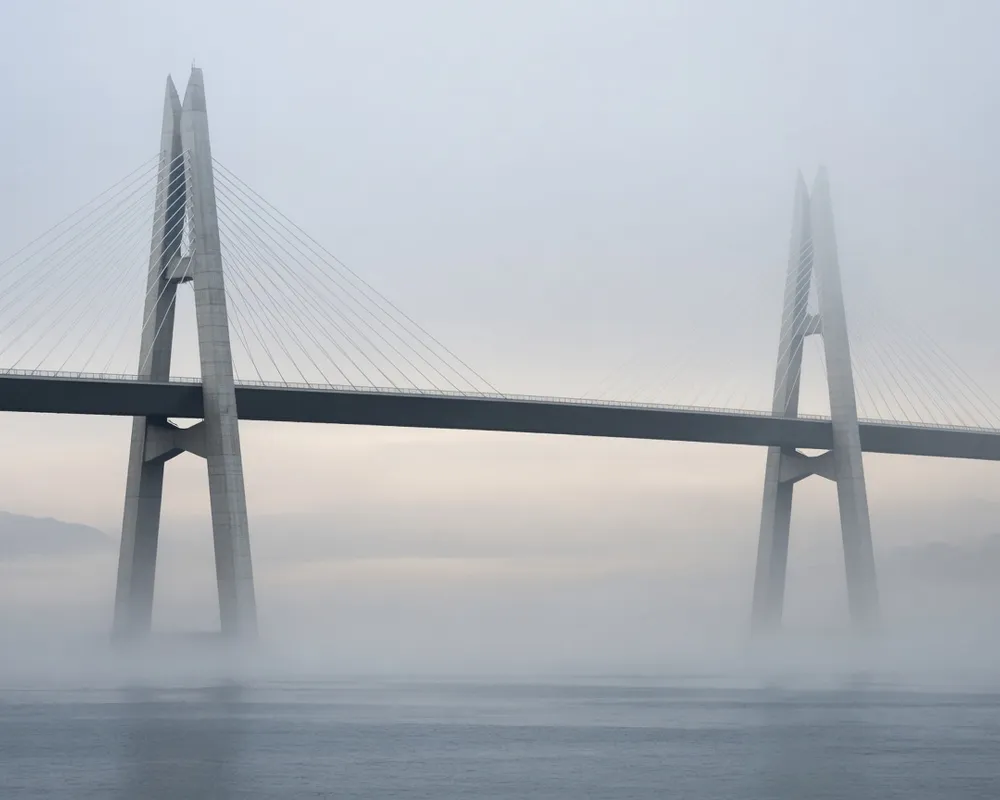 Editorial photograph of twin pylons with a connecting span